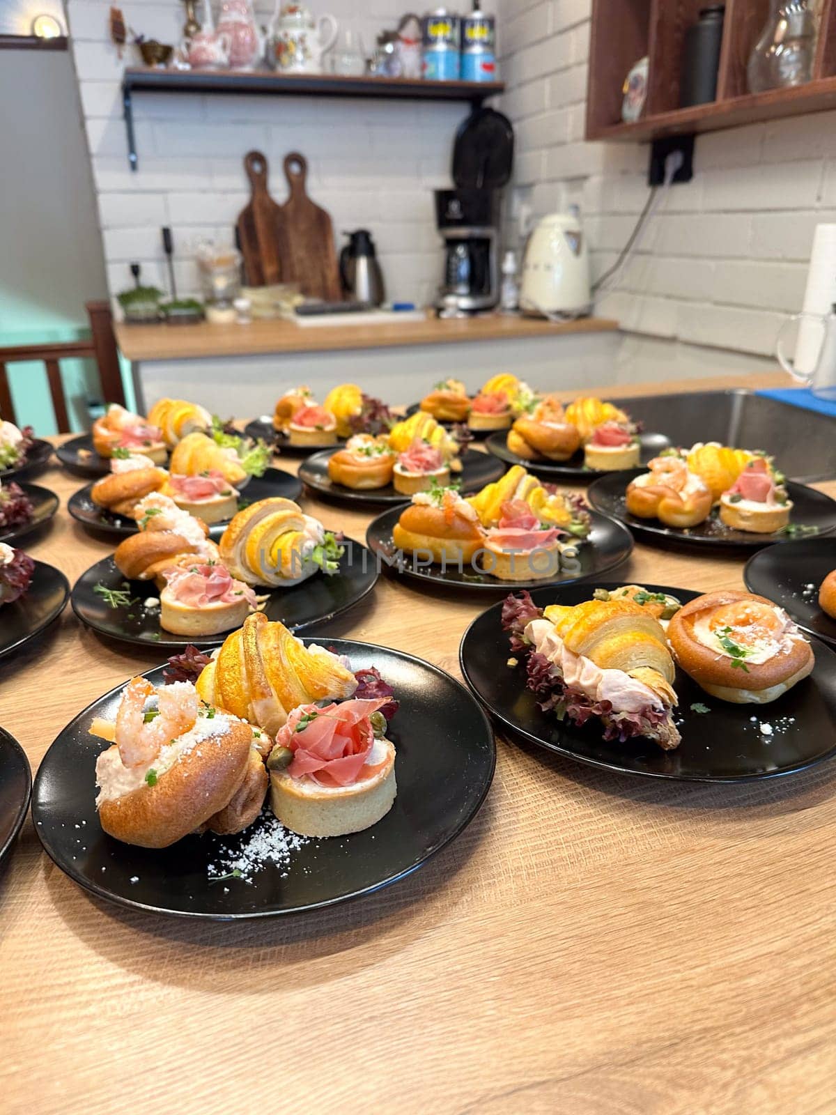 Gourmet appetizers elegantly arranged on black plates. Colorful presentation and variety of flavors, luxurious dining experience. Food and buffet concept.