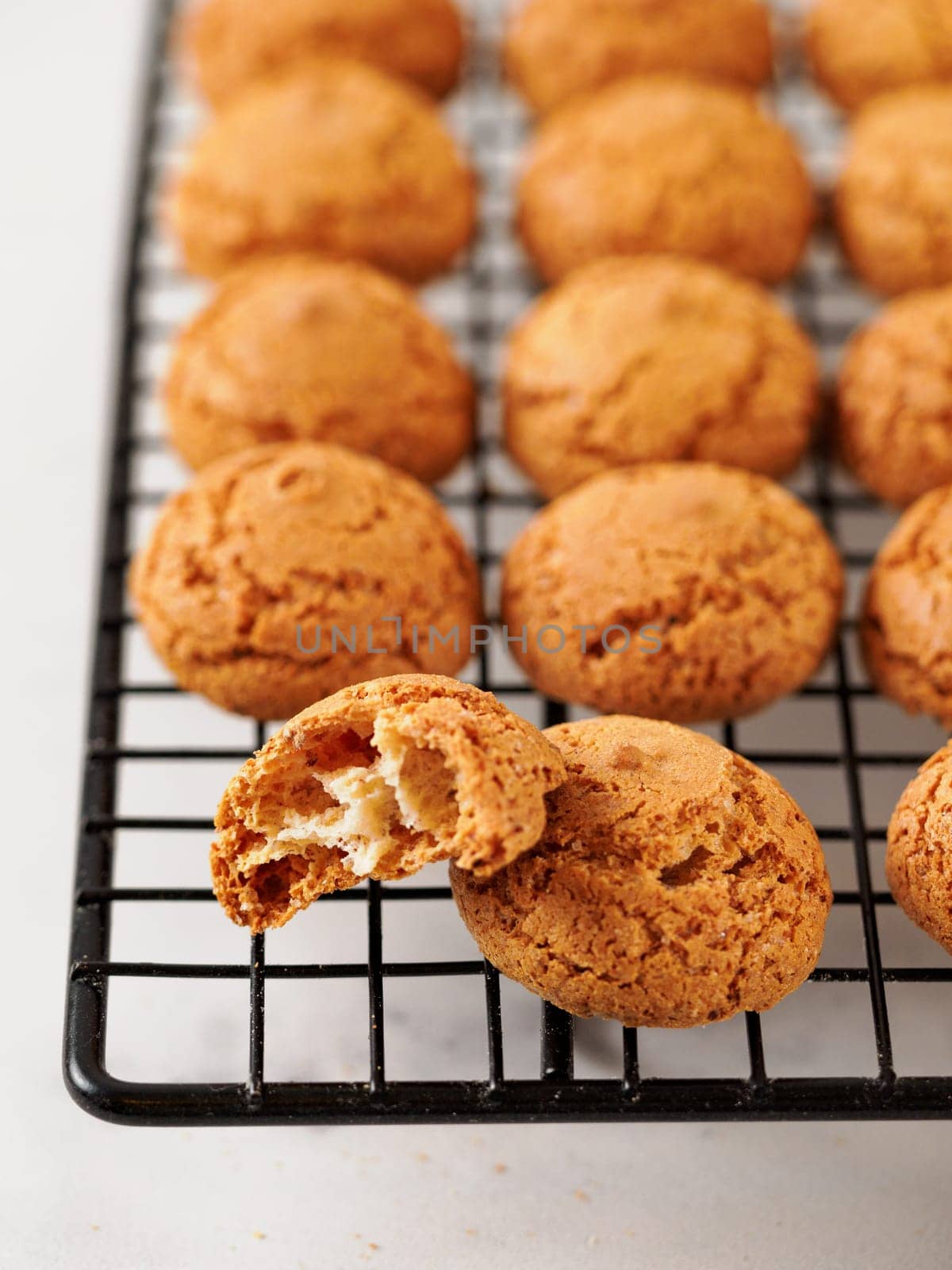 Amaretti cookie on cooling rack - traditional Italian Sardinian pastry. Delicious amaretti biscuit cookies made from almond or apricot kernels with copy space