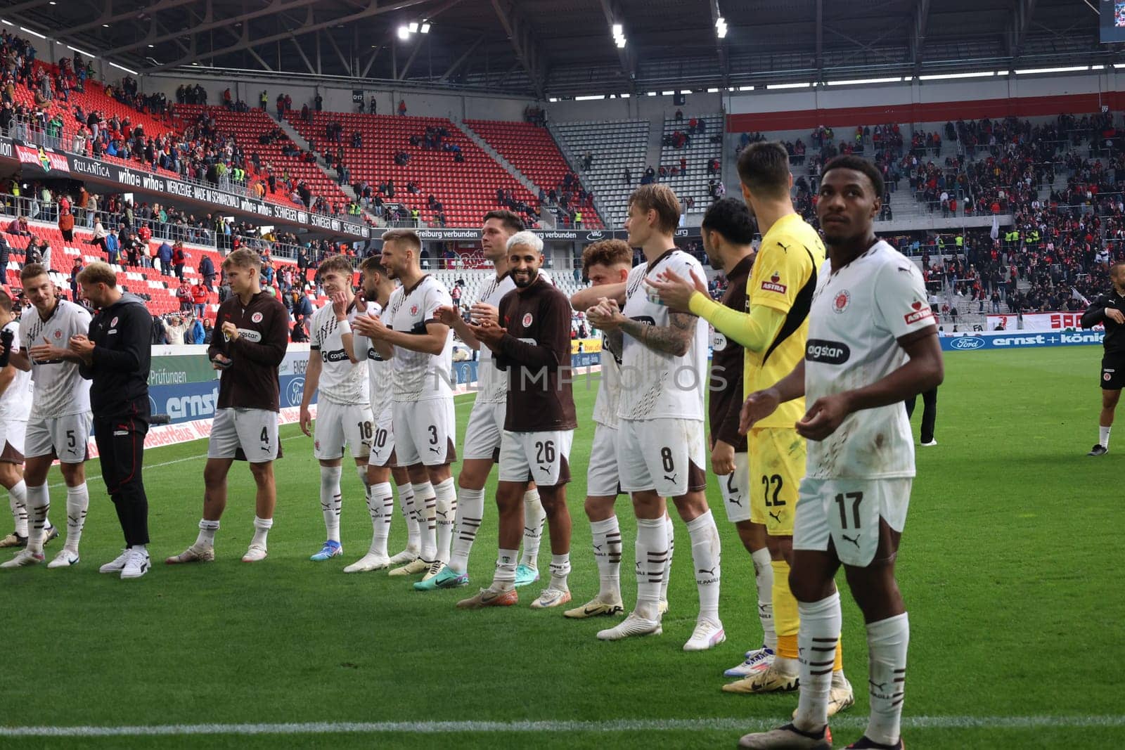The players of newly promoted FC St. Pauli are celebrated by their own fans after the 0:3 victory in Freiburg after the match of the 1st FBL: 24-25: 1. FBL: 24-25: 5. Sptg. SC Freiburg - FC St. Pauli  DFL REGULATIONS PROHIBIT ANY USE OF PHOTOGRAPHS AS IMAGE SEQUENCES AND/OR QUASI-VIDEONann  Photo: Joachim Hahne/johapress