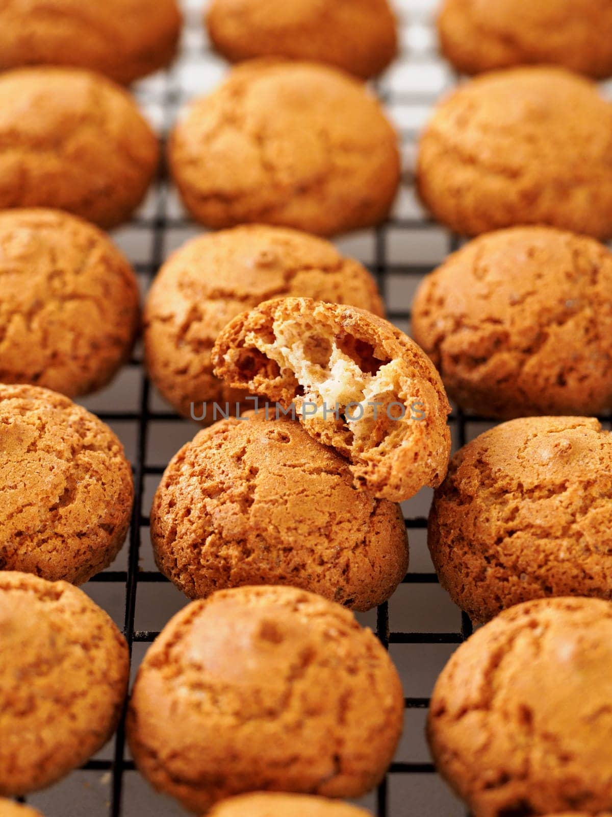 Amaretti cookie on cooling rack - traditional Italian Sardinian pastry. Delicious amaretti biscuit cookies made from almond or apricot kernels with copy space