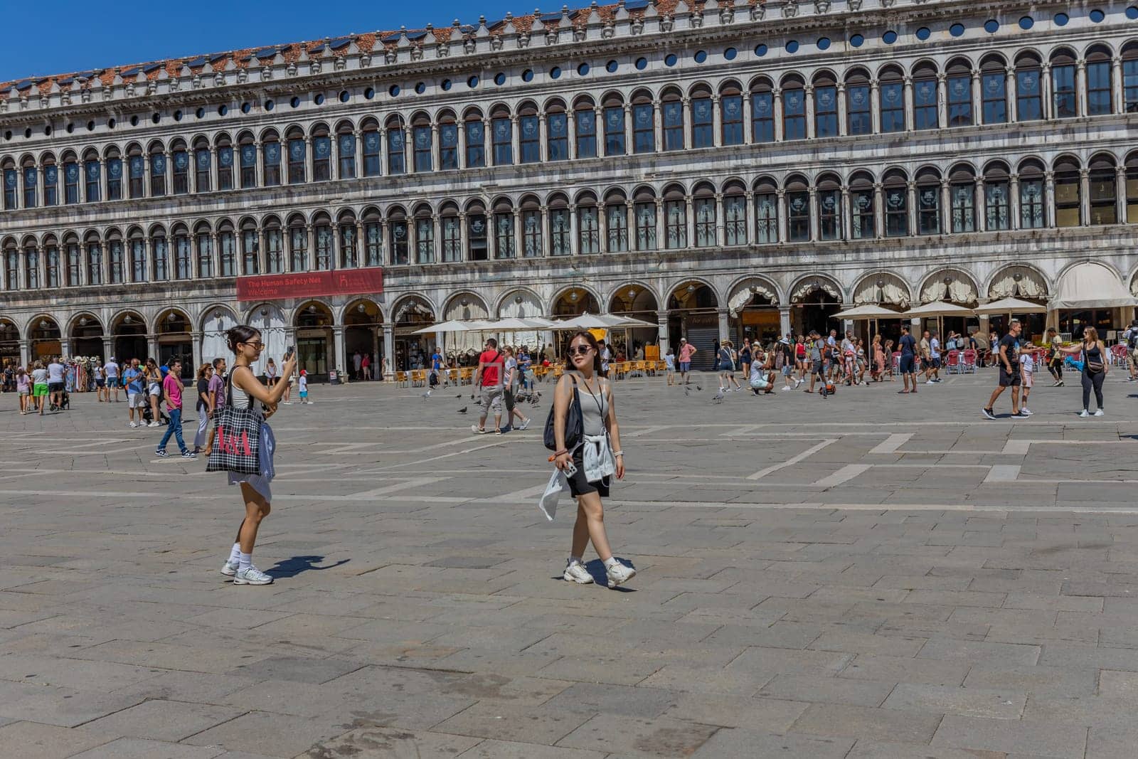 Venice, Italy - July 26, 2024: Asian tourist standing on San Marco square. Venice is very popular tourist destination. Venice, Italy