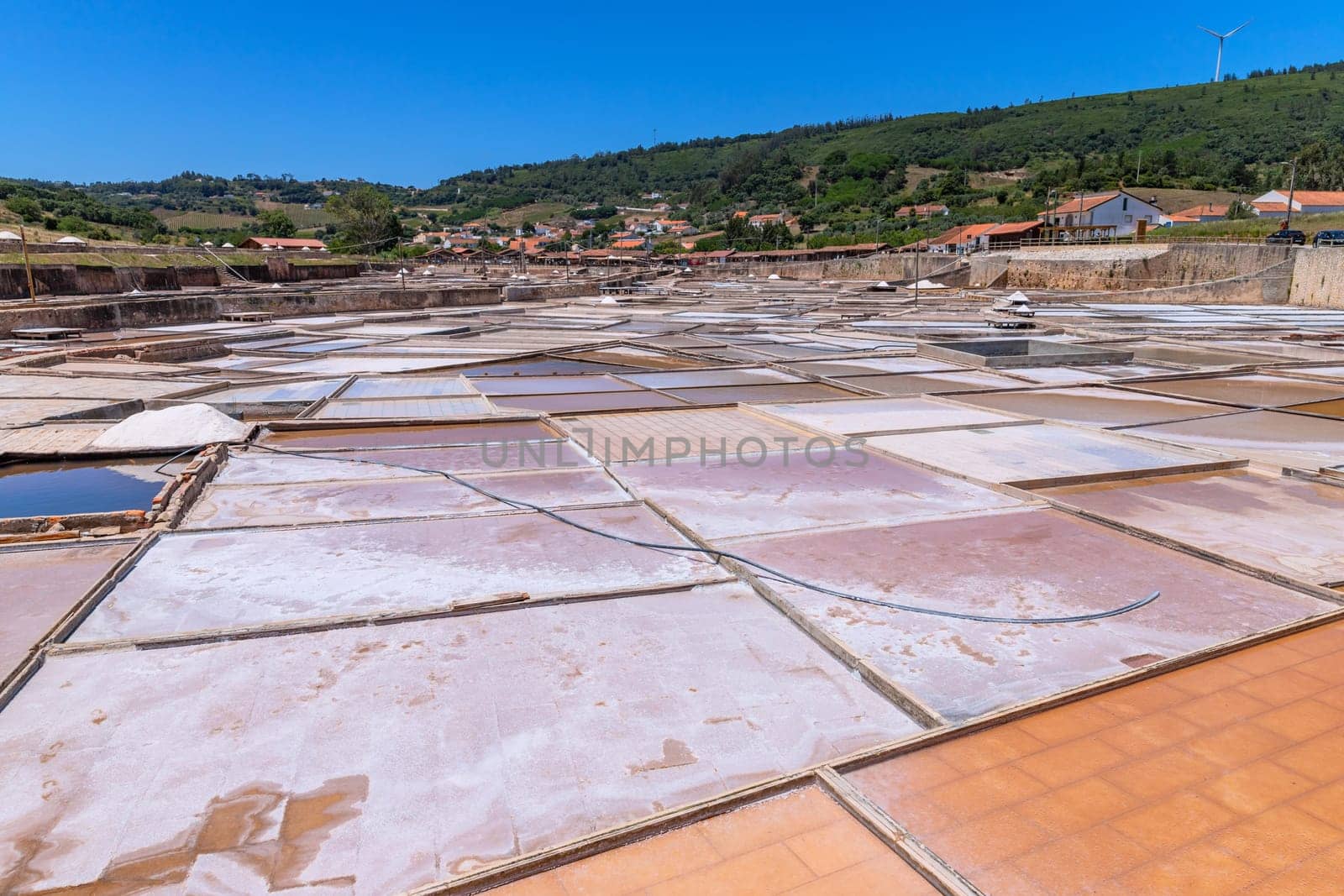 Rio Maior, Portugal: July 7, 2024: Fonte da Bica Salt Flats, aka Salinas de Rio Maior, system of shallow water compartments and gutters for salt extraction, Portugal
