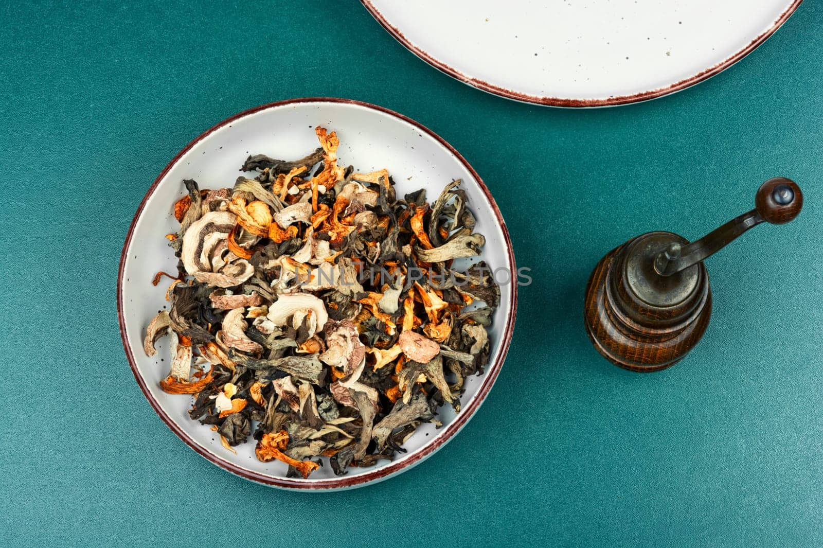 A vibrant array of dried mushrooms on a rustic wooden table. Space for text.