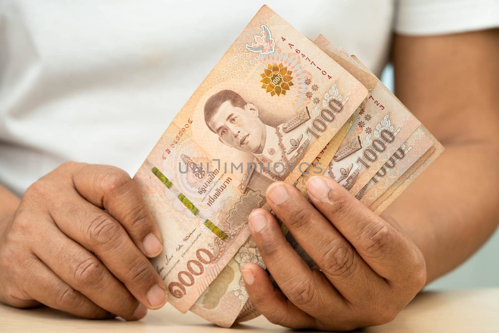 Asian woman counting Thai baht banknote money, investment economy, accounting business and banking.