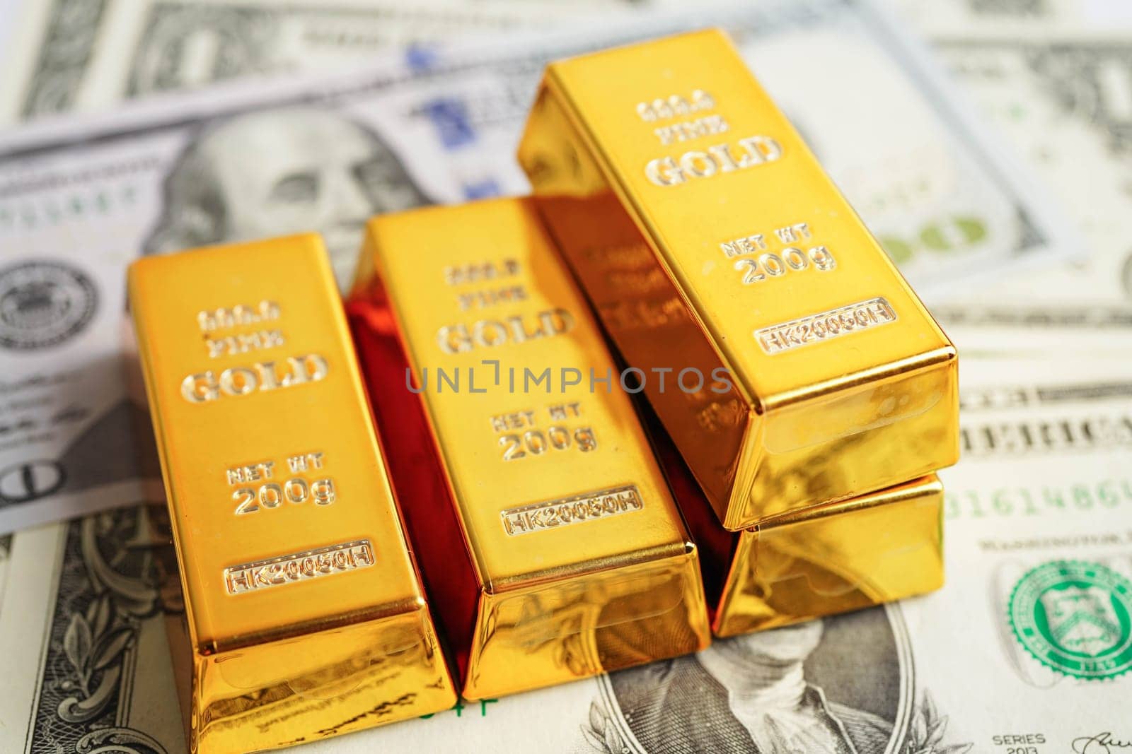 Gold bars with US dollar and Euro banknote money, finance trading investment business currency.