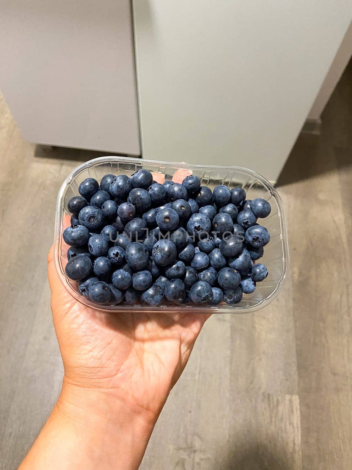 Fresh blueberries on box close-up, background.