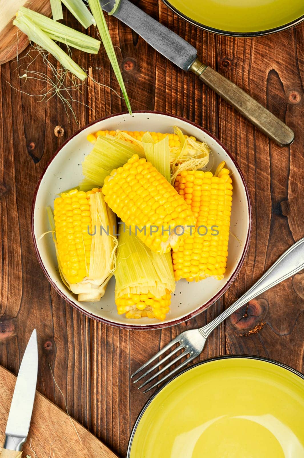 Appetizing sweet boiled corn on wooden background. Flavored boiled corn.