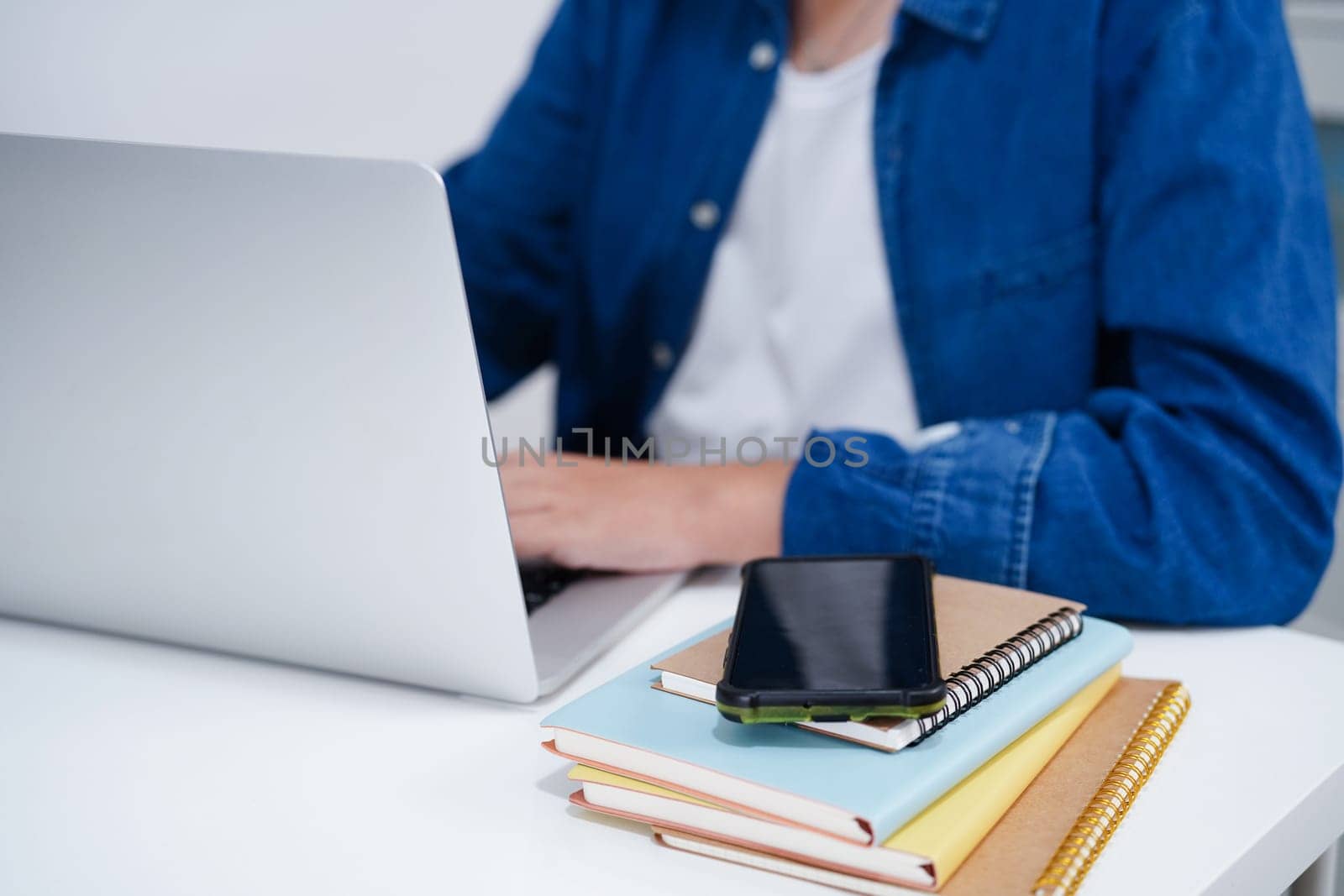 Asian teenage student write homework with laptop computer, learning university education concept.