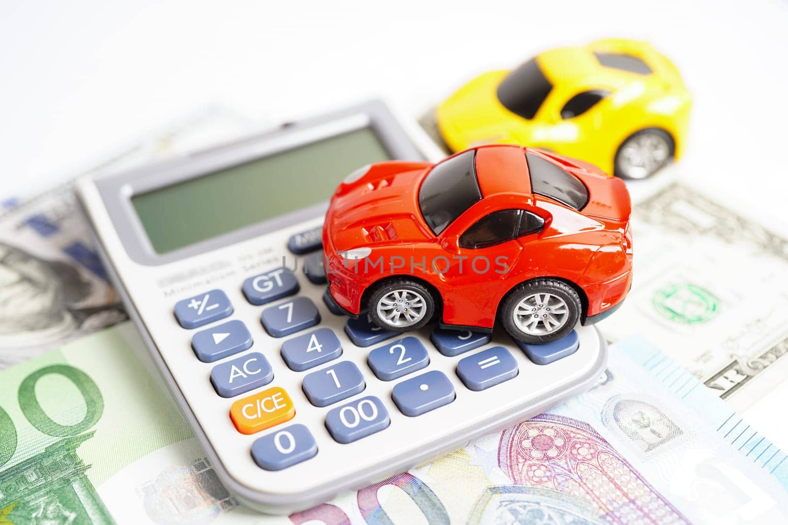 Bangkok, Thailand November 18, 2023 Car on banknote money with calculator, buying or insurance concept.