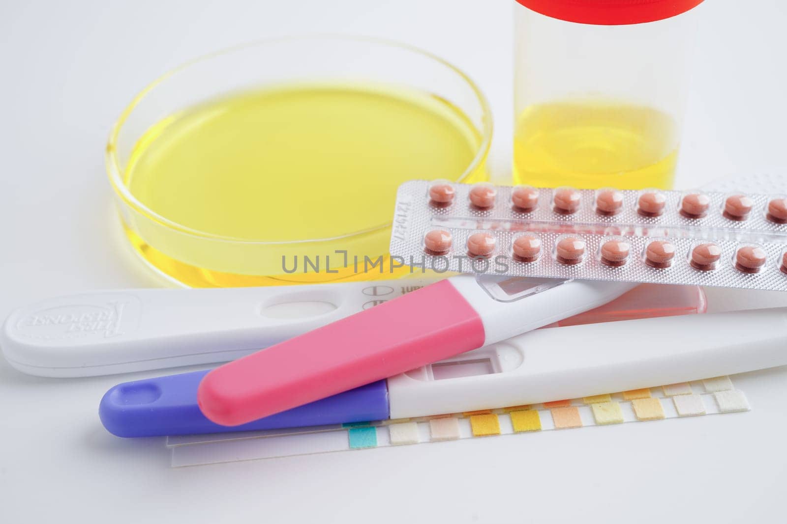 Urinalysis, pregnancy test and urine cup for female of ovulation day, fetus, maternity, childbirth, birth control.