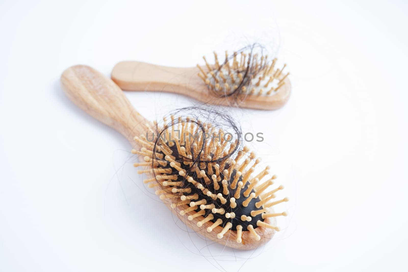 Hair loss fall with comb brush isolated on white background.