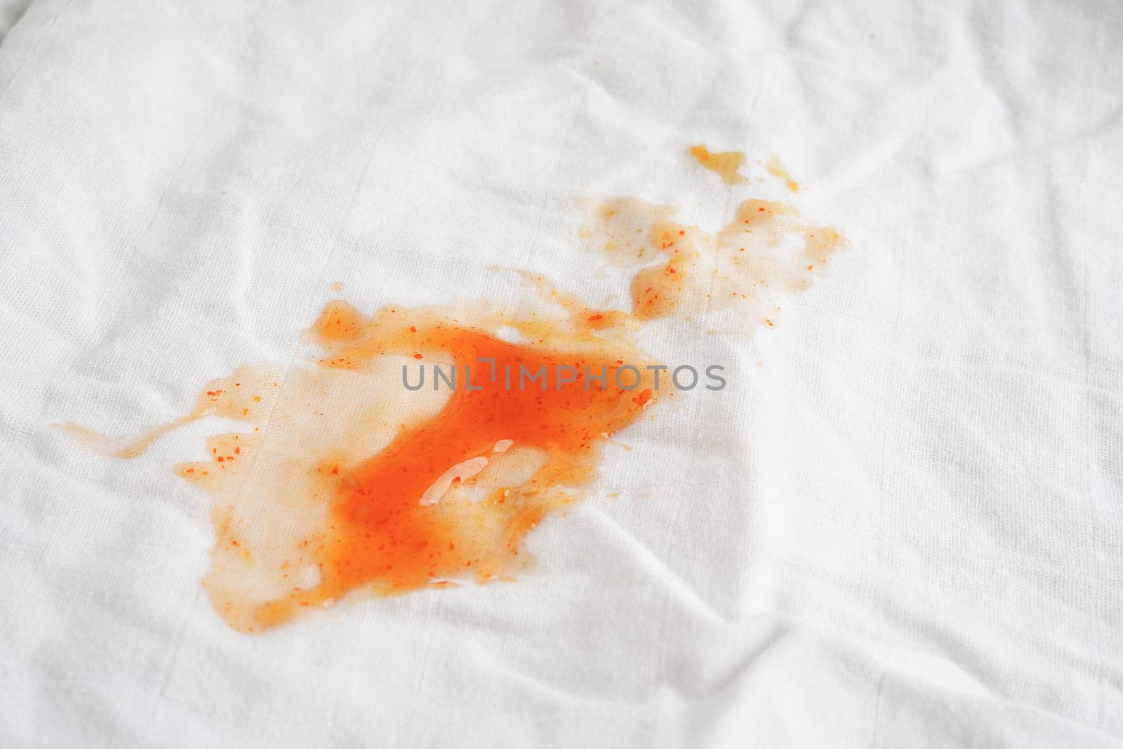Dirty tomato sauce stain or ketchup on cloth to wash with washing powder, cleaning housework concept.