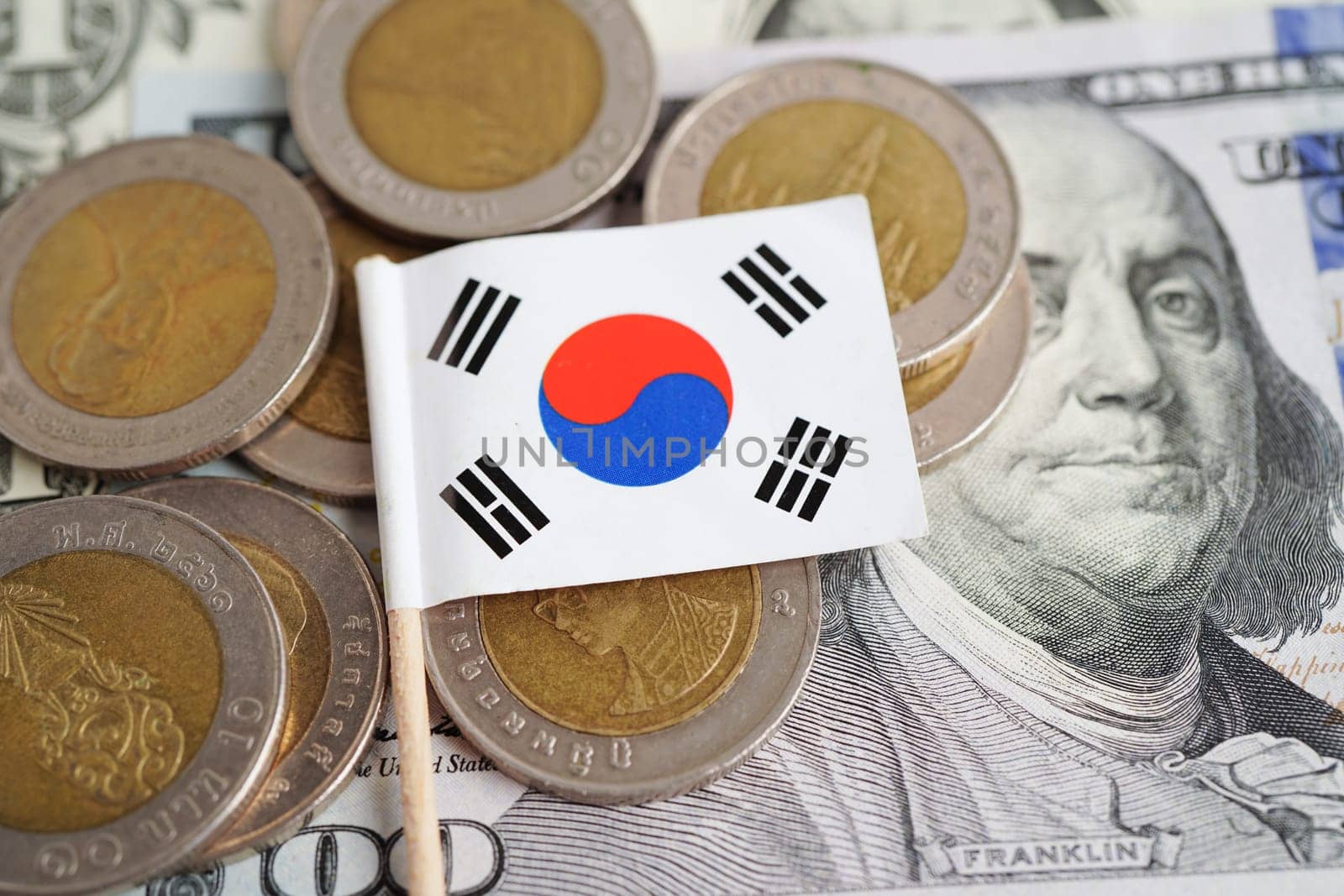Korea flag on coin and banknote money, finance trading investment business currency concept.