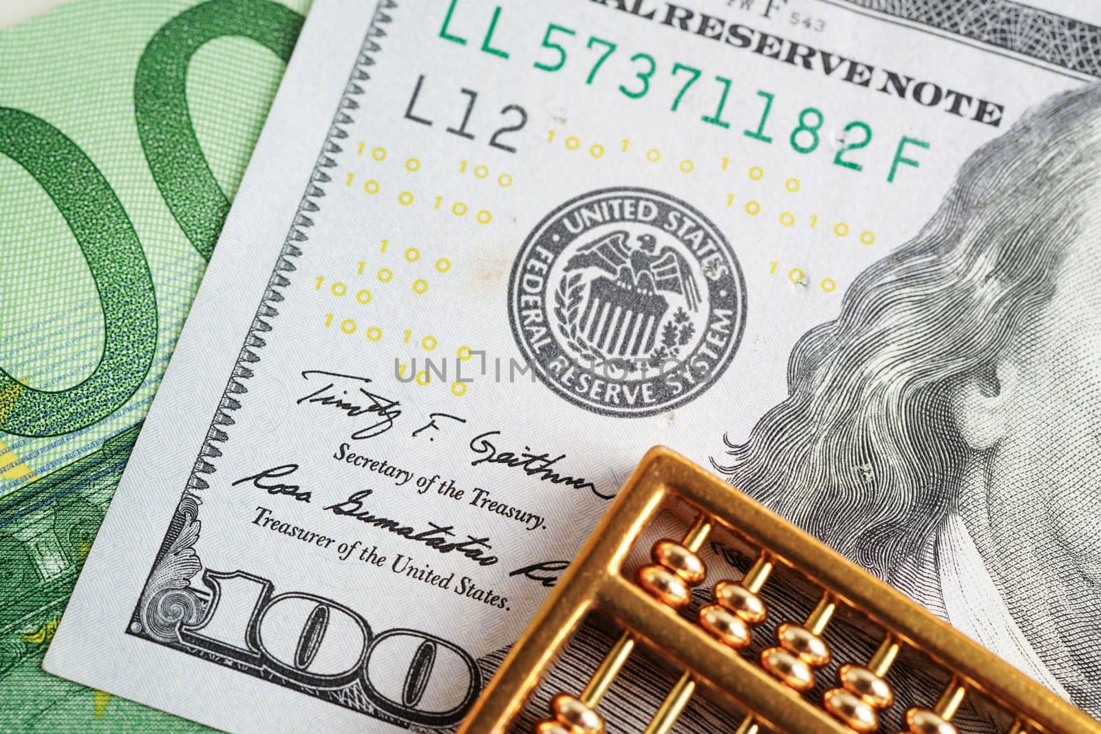 Gold abacus on banknote money, finance trading investment business currency concept.
