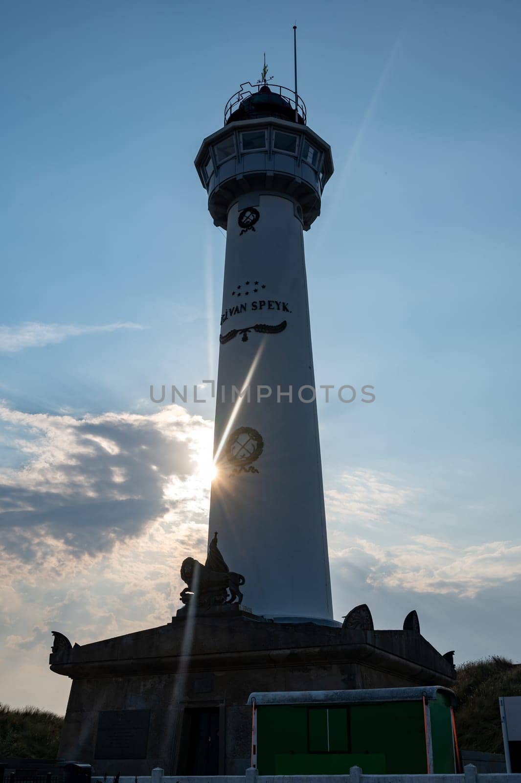 The approx. 28 m high white lighthouse J.C.J. van Speijk in Egmond aan Zee, North Holland, Netherlands at sunset