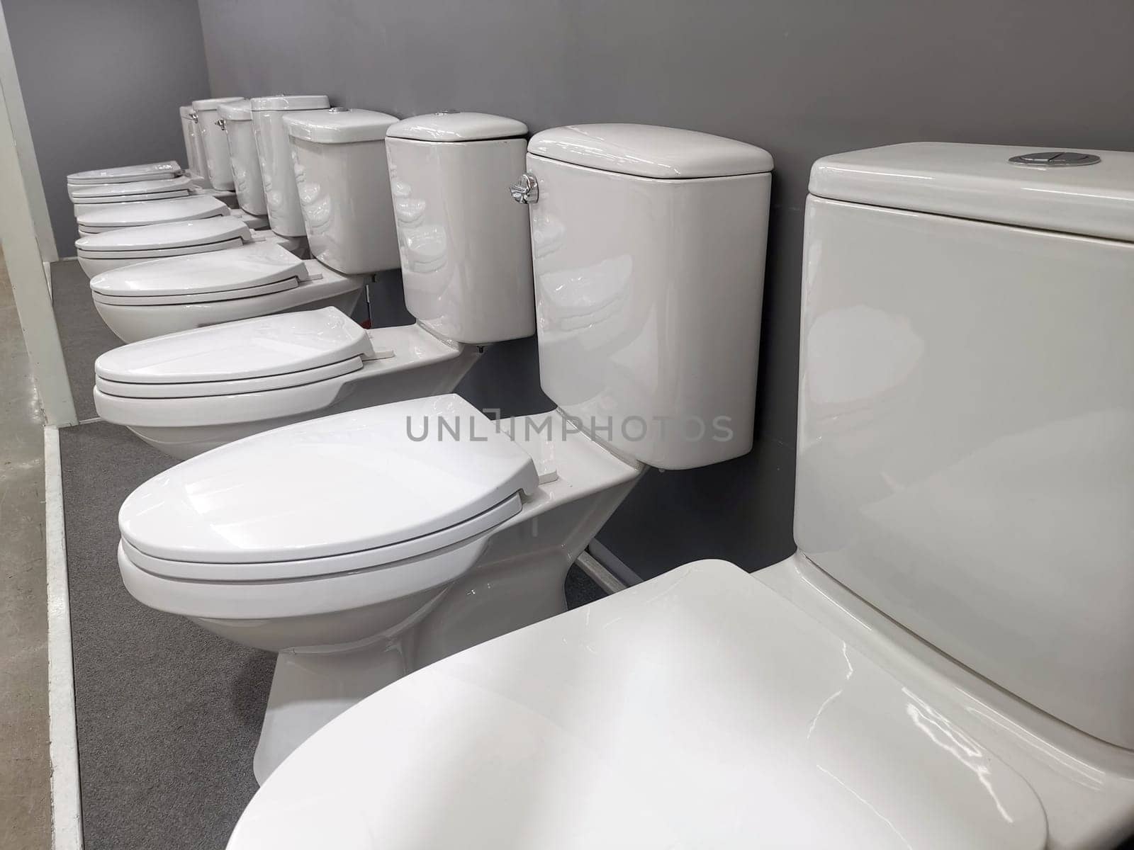 New modern toilet in the plumbing store. Samples of modern sanitary ware for the toilet