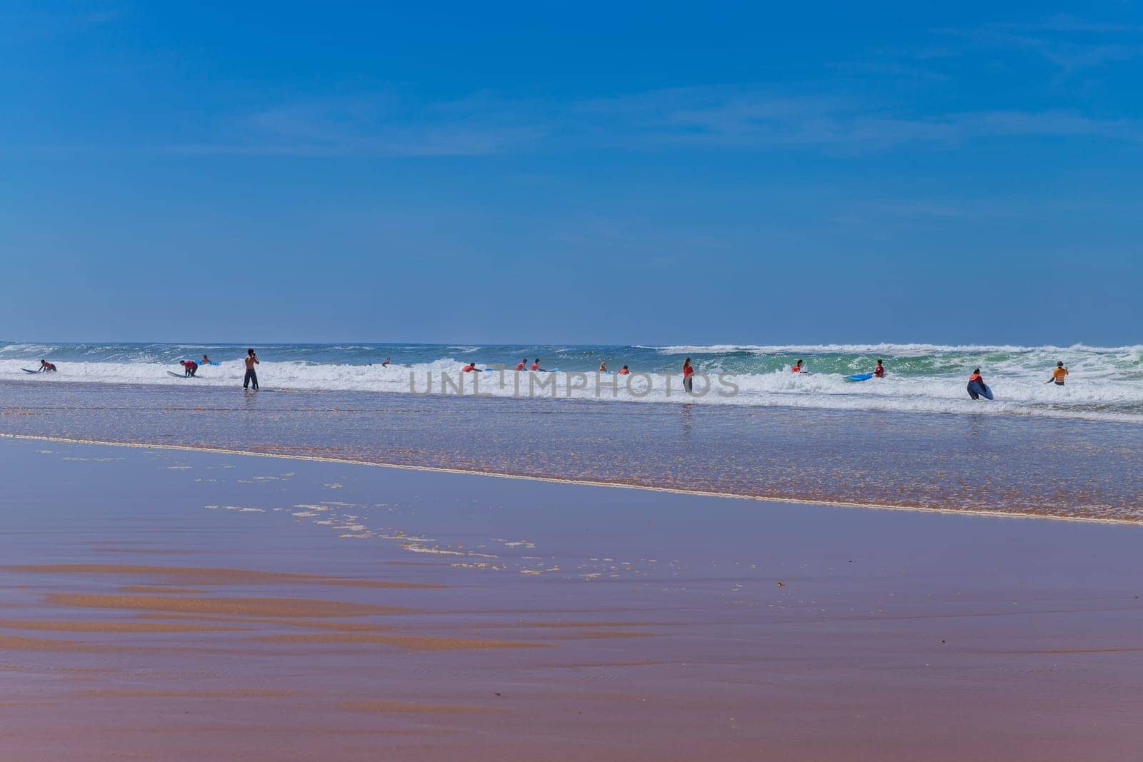 Ericeira, Portugal: April 13, 2024: Group of surfers with surfboards going to surfing. Ericeira is the famous surfing destination in Portugal.