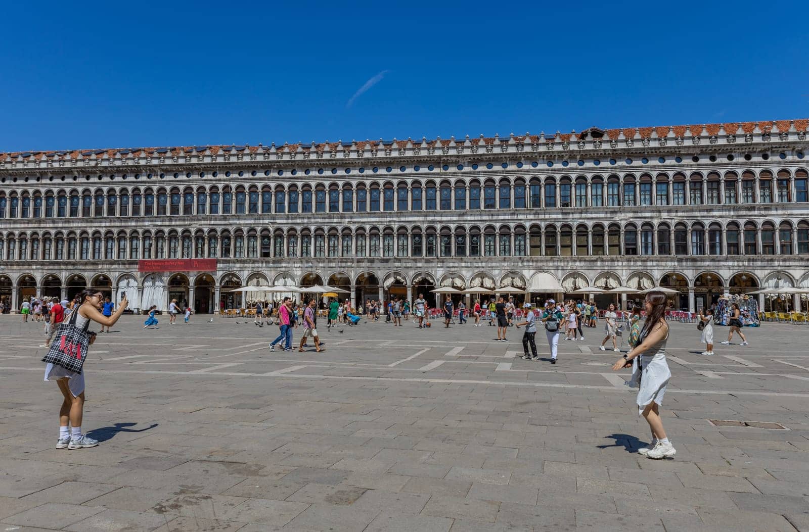 Venice, Italy - July 26, 2024: Asian tourists standing on San Marco square. Venice is very popular tourist destination. Venice, Italy