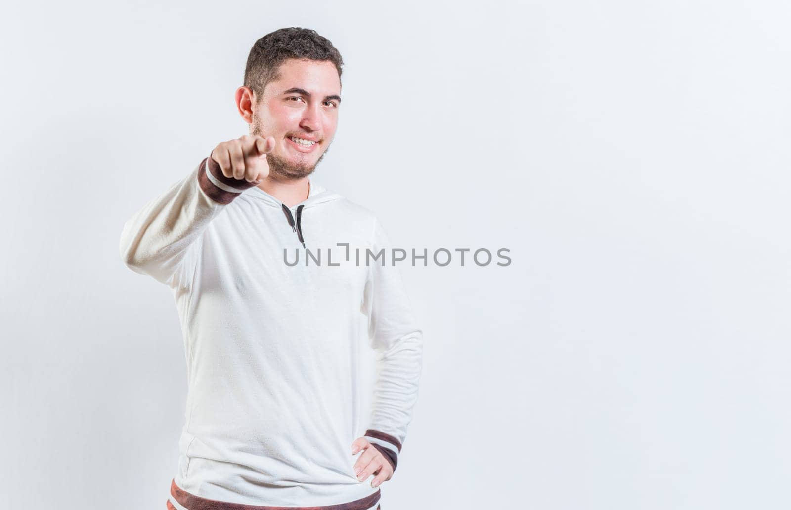 Happy teenage guy pointing at you on isolated background. Attractive cool guy pointing at the camera isolated