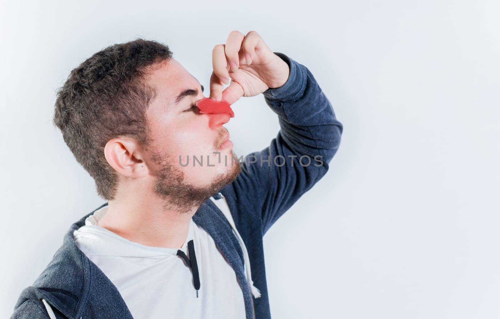 Concept of nasal congestion and nosebleed. Person with nosebleed isolated