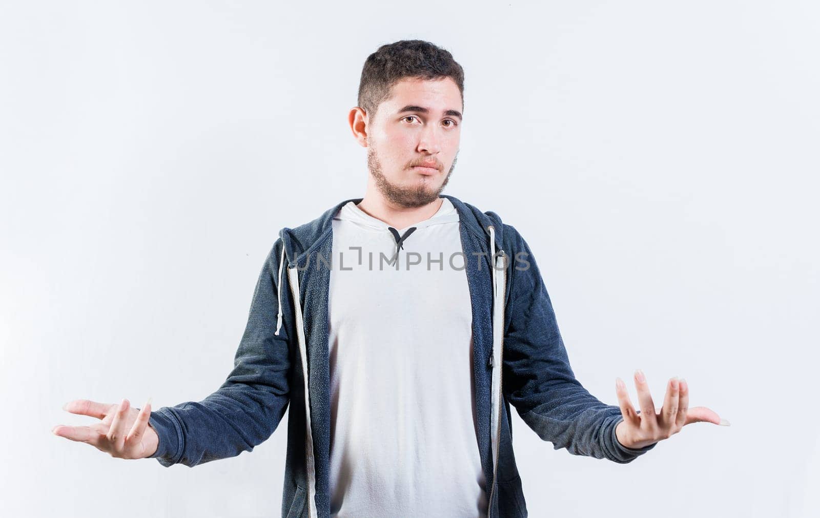 Puzzled person spreading hands isolated. Clueless young man with open arms