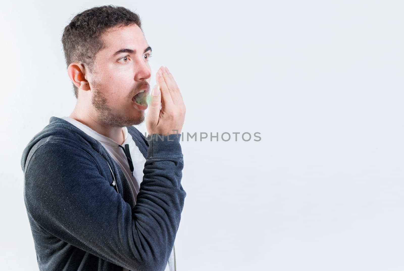 Person with bad breath problem isolated. Man with latisosis checking bad breath