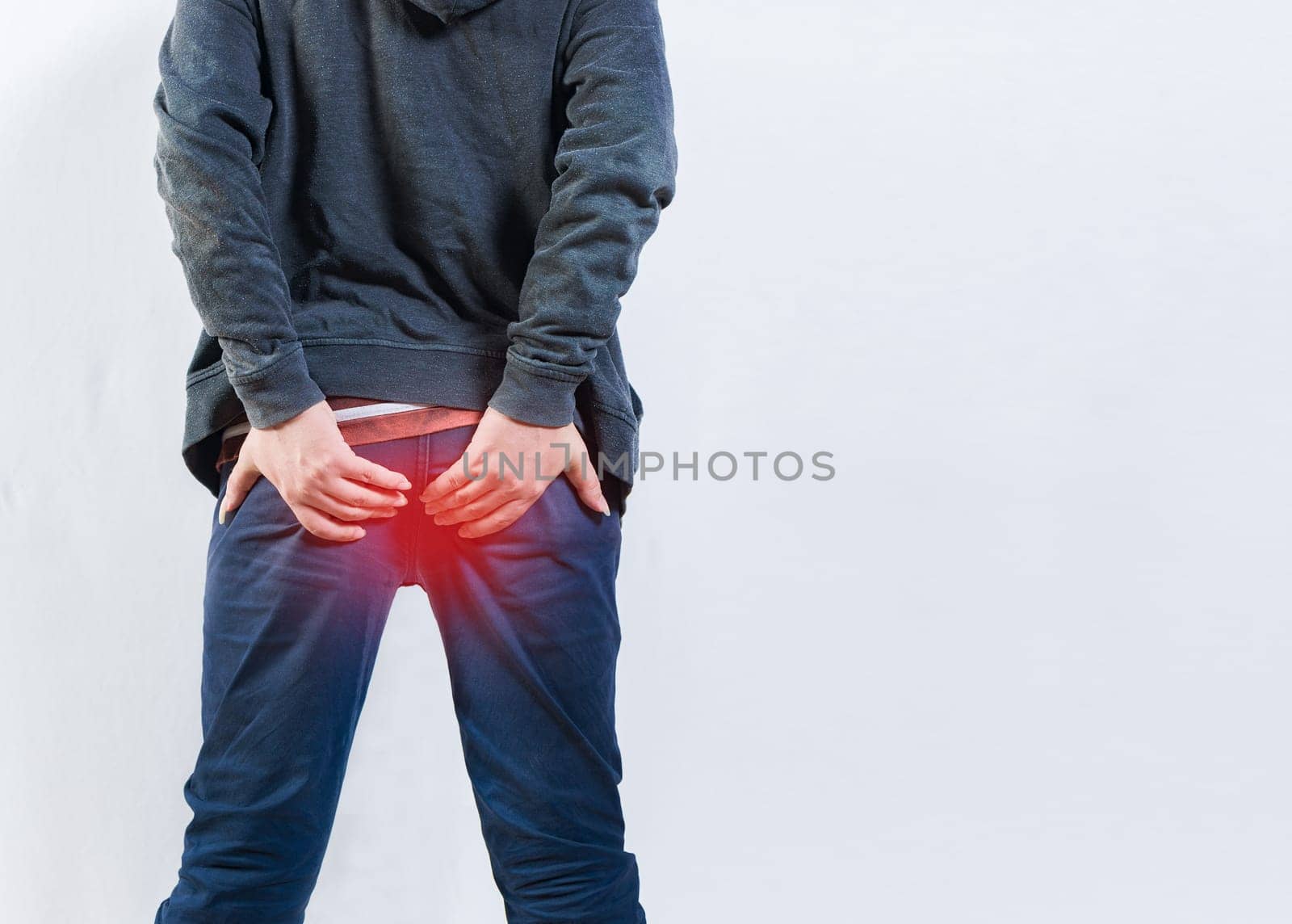 Person with hemorrhoid problem isolated. Unrecognizable man with hemorrhoids and constipation problems