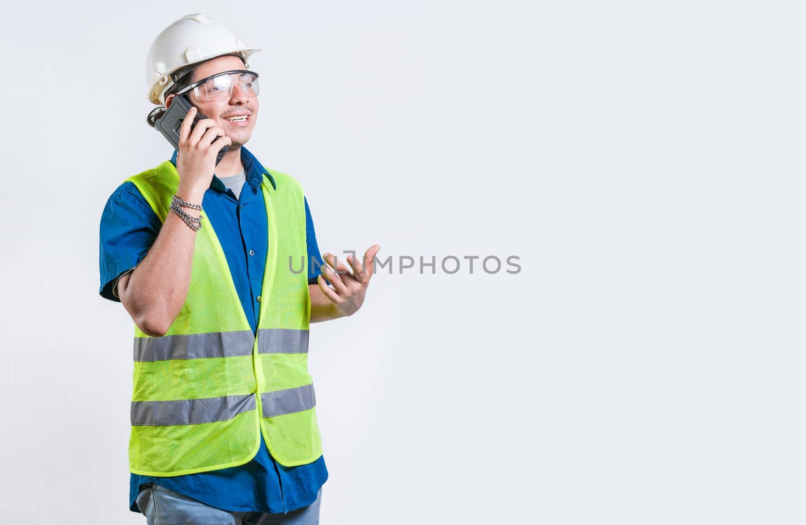 Civil engineer talking phone isolated. Young latin engineer calling on cell phone isolated
