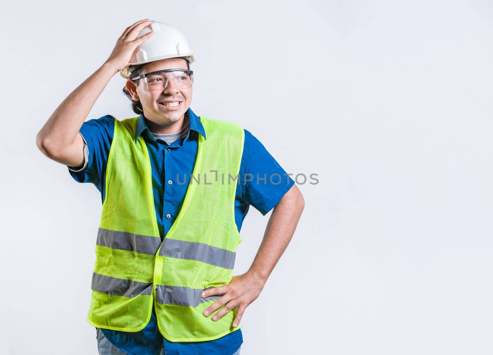 Troubled young engineer holding head isolated. Worried builder engineer holding head isolated. Engineer in problems concept