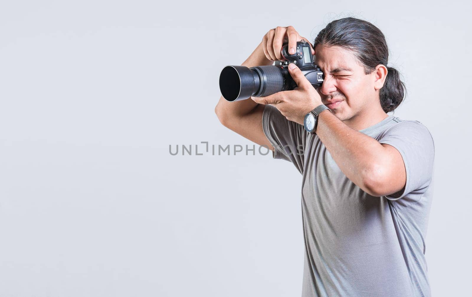 Male photographer taking photos isolated. Handsome photographer taking photos with dslr camera isolated