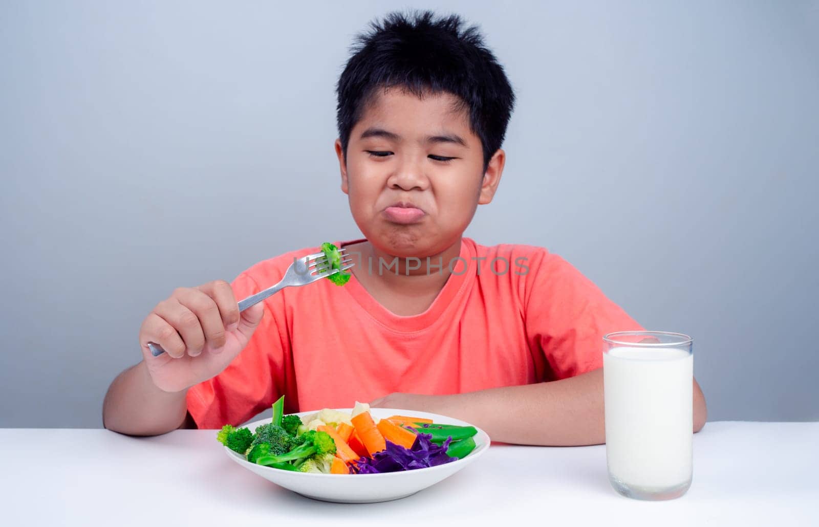 Children do not like to eat vegetables, Little cute boy refuses to eat healthy vegetables, Nutrition healthy eating habits for kids concept, Children do not like to eat vegetables.