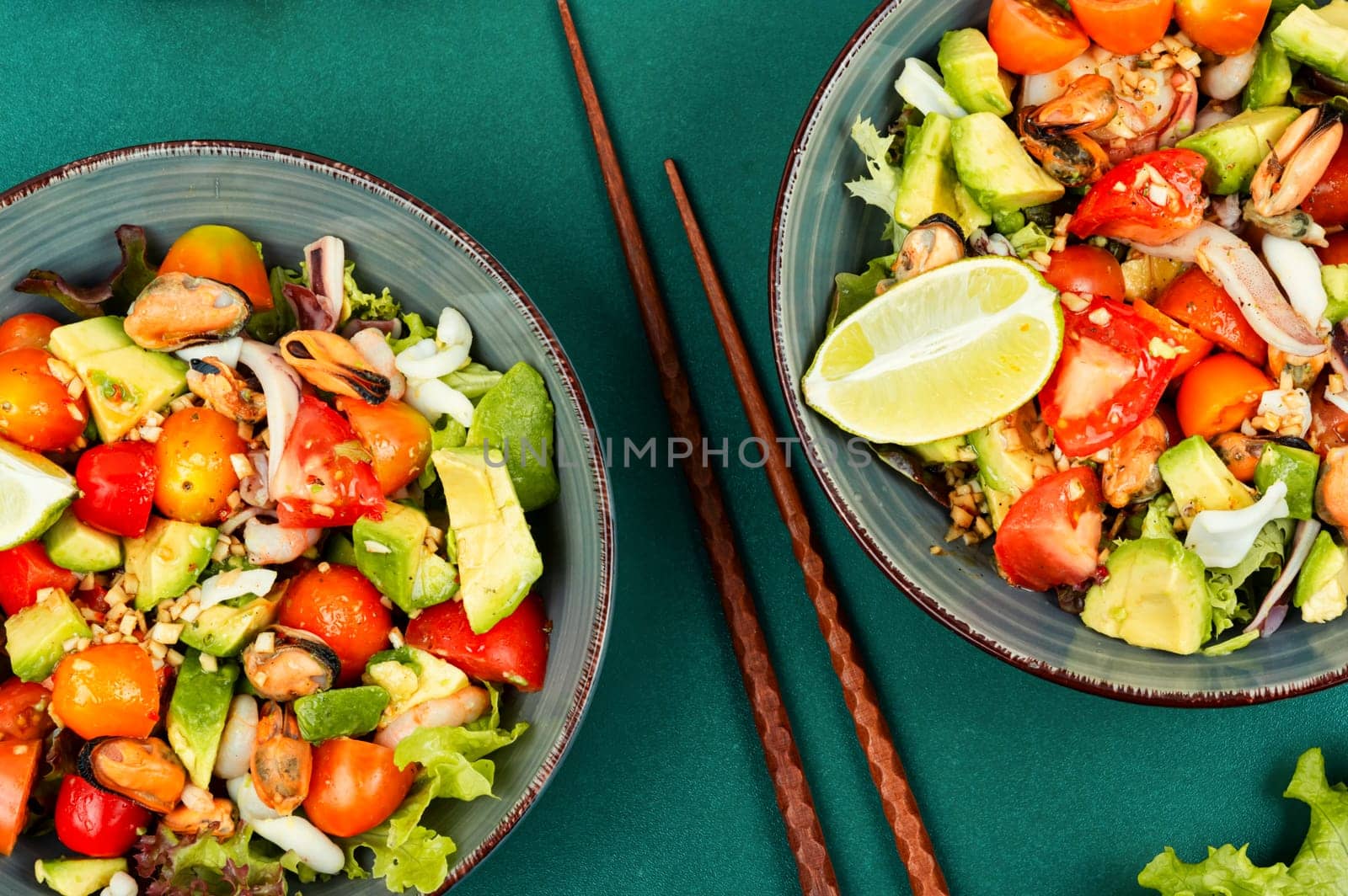 Seafood salad with shrimp, octopus, mussels, tomatoes, avocado and mixed greens. Healthy food. Flat lay with copy space