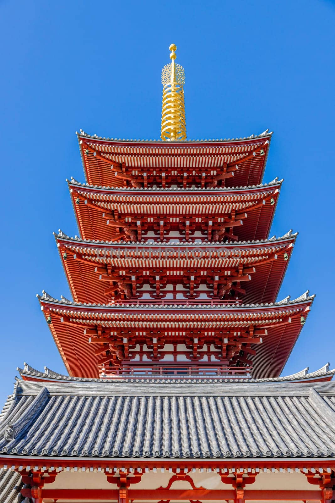senso ji  pagoda towering over a temple roof with elaborate details, tokyo