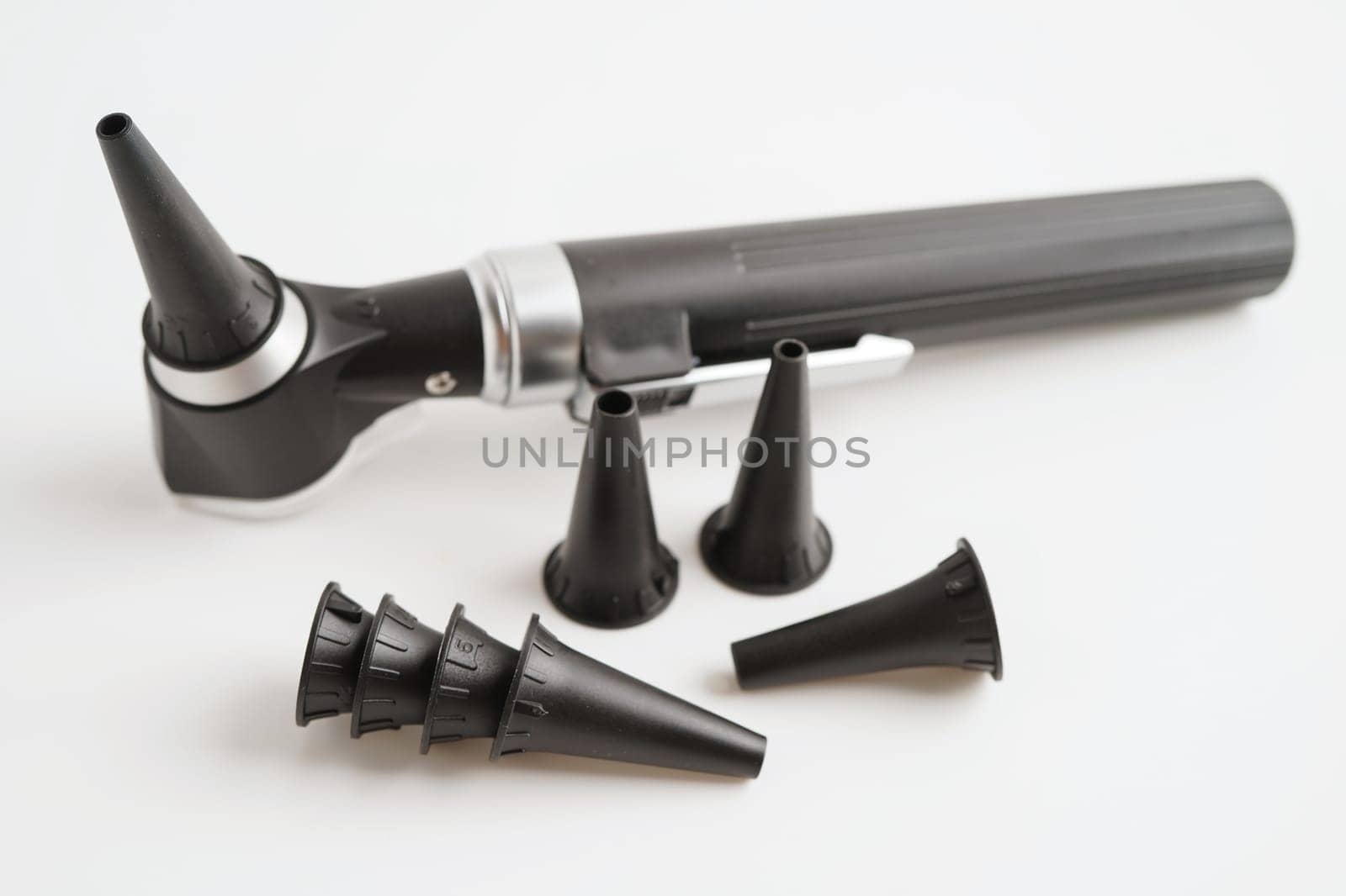 Otoscope isolated on white background for otolaryngologist or ENT physician doctor examining senior patient ear, hearing loss problem.