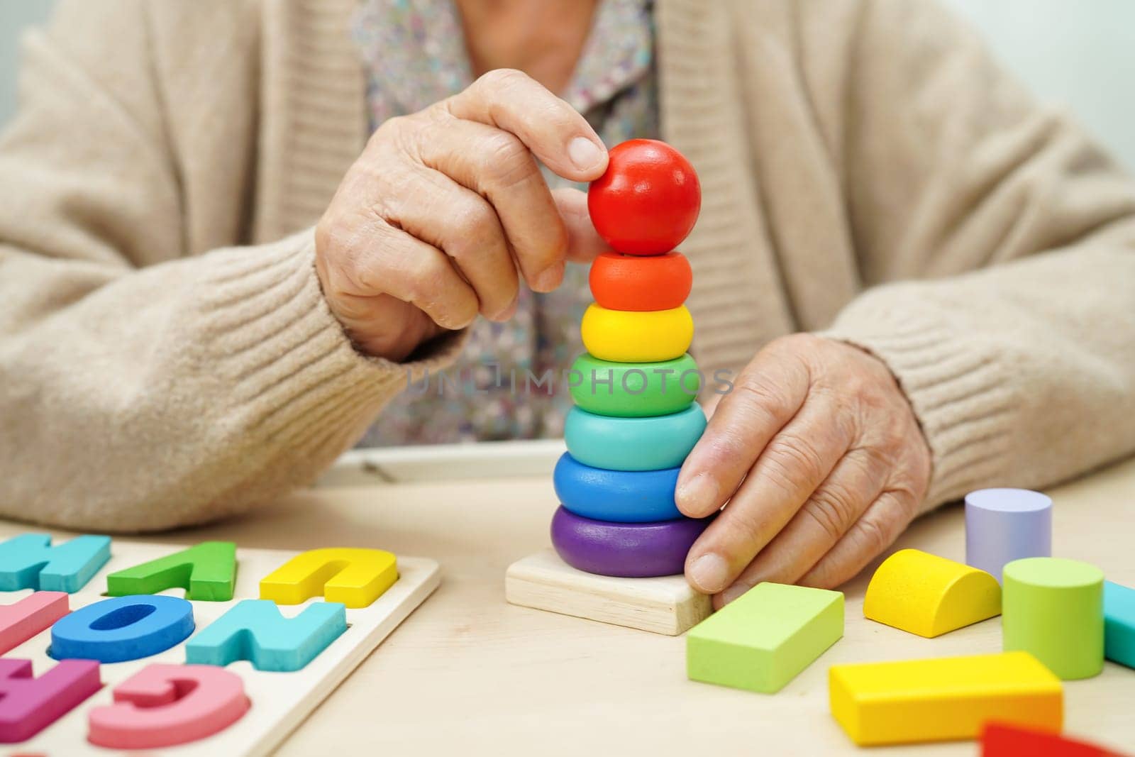 Asian elderly woman playing game.
