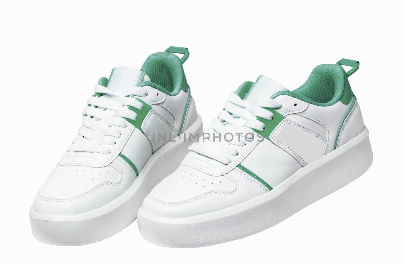 White sneaker. Close-up of a pair white elegant stylish female leather high-heeled sport shoes isolated. Clipping path. Womens shoe fashion. Modern design footwear for workout.
