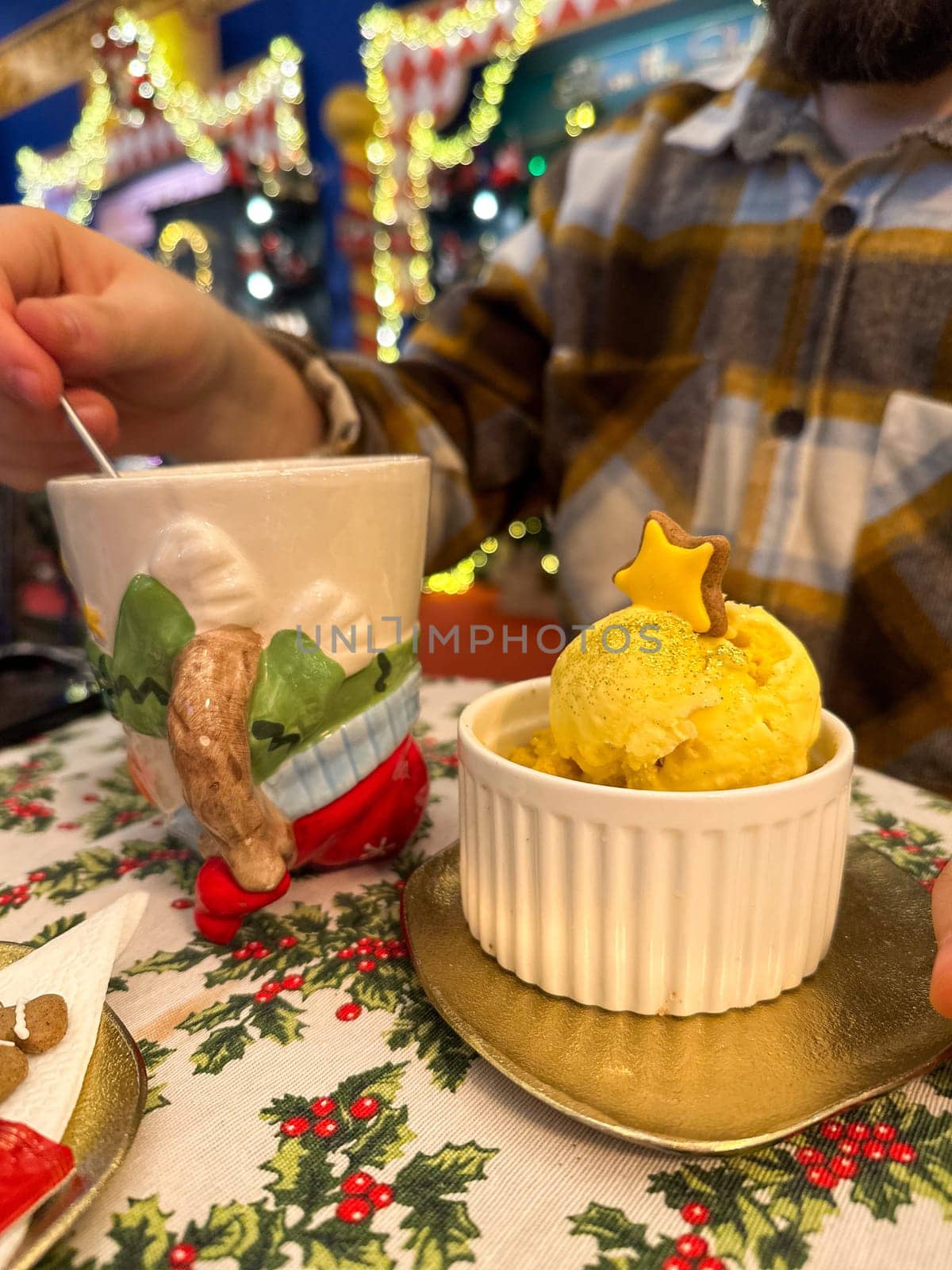 Festive dessert table with holiday-themed decorations. a warm crumble topped with a scoop of ice cream and a Christmas tree decoration captures the cozy atmosphere of a winter celebration. Festive and joyful winter celebrations. Xmas treats.