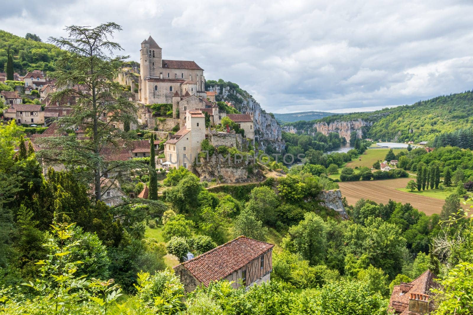 Old cliffside village of Saint-Cirq-Lapopie and his church in the Occitanie region of South West France