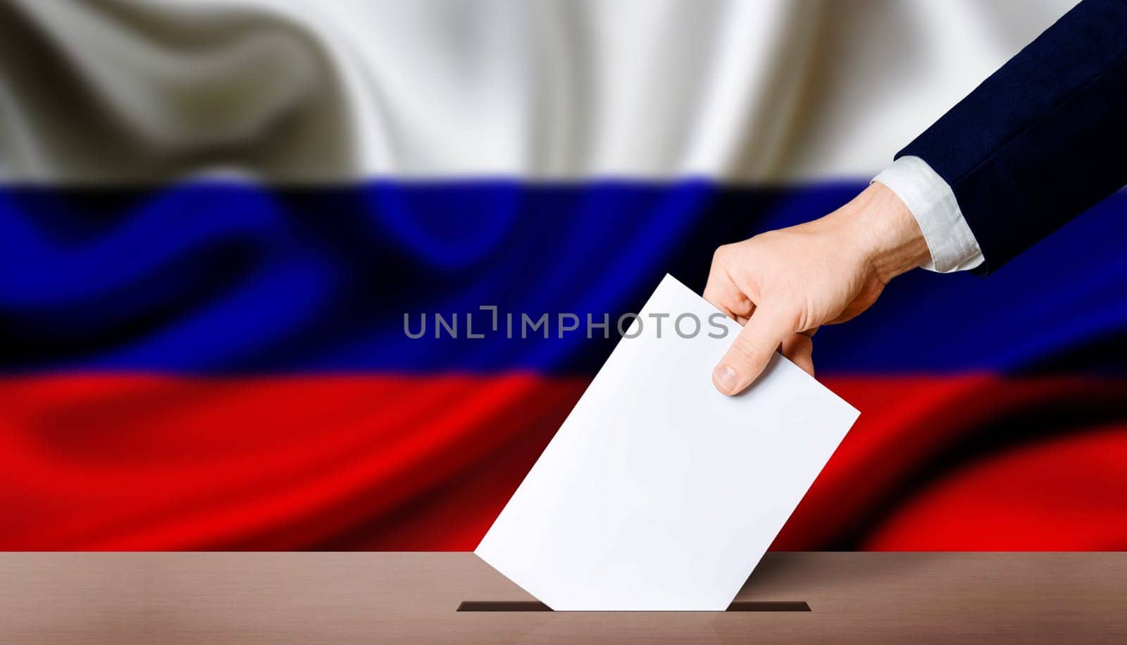Presidential elections of the Russian Federation. Hand holding ballot in the ballot box with Russia flag in the background