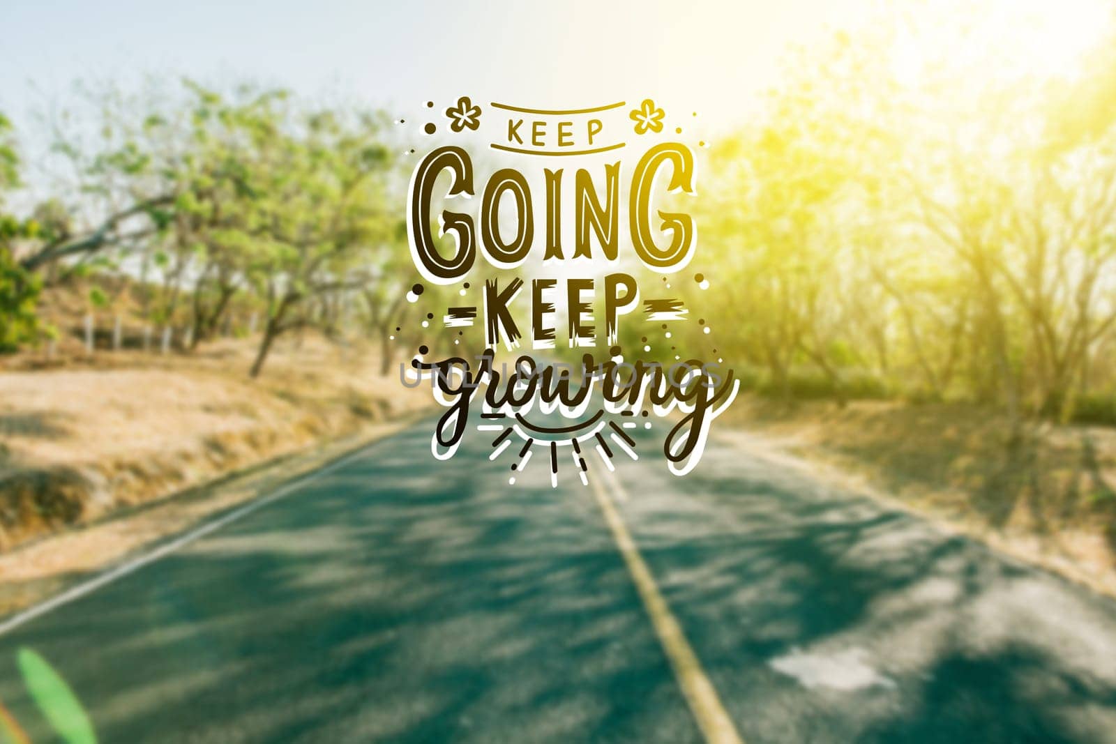 Asphalt road with motivational phrase, KEEP GOING, KEEP GROWING. Road concept with motivational message