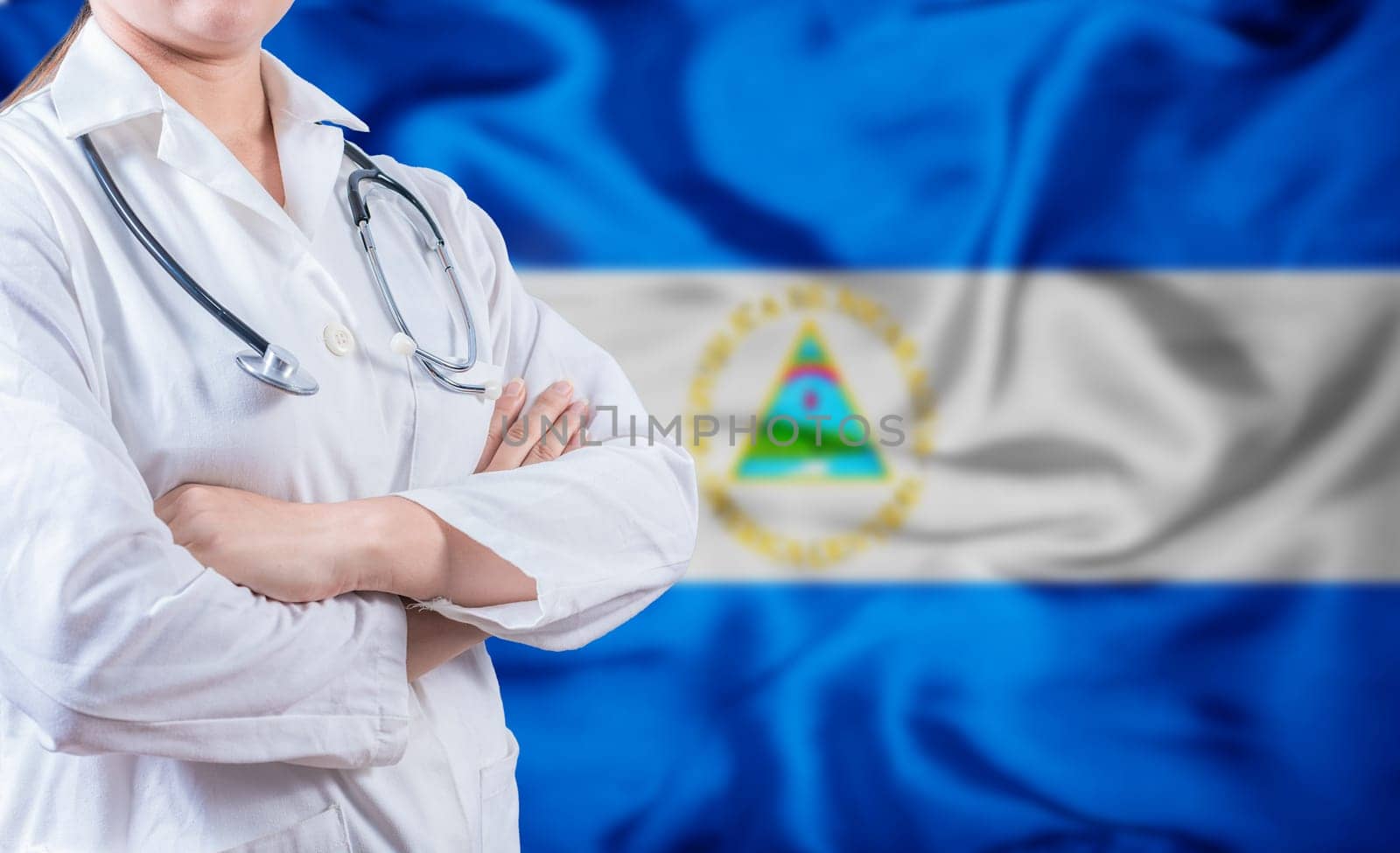 Doctor with stethoscope on Nicaraguan flag. Nicaragua Health and Care concept. Doctor with crossed arms on Nicaragua flag background