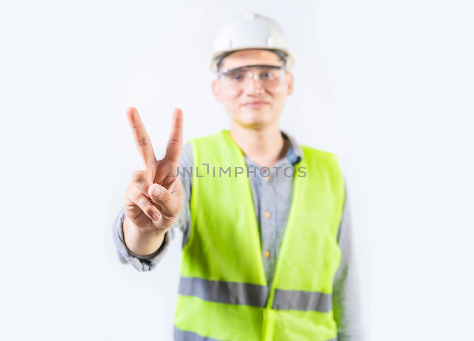 Young engineer counting number two isolated. Male engineer showing number two isolated