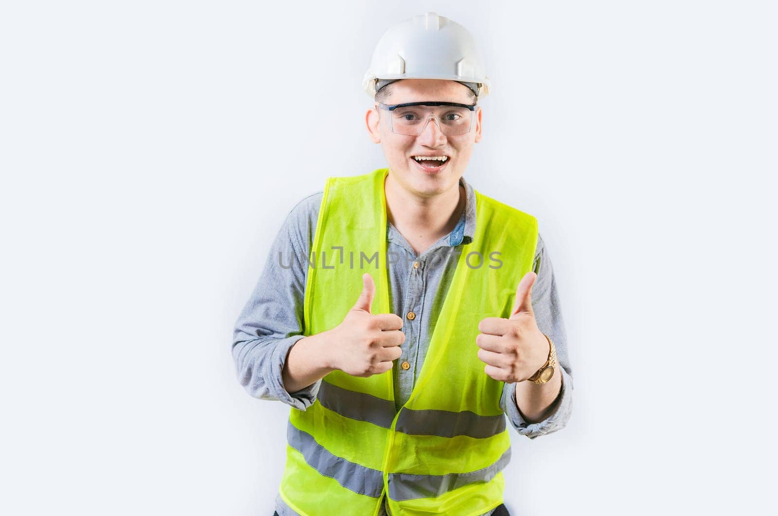 Positive young engineer showing ok gesture isolated. Handsome engineer gesturing ok approved isolated, smiling at camera
