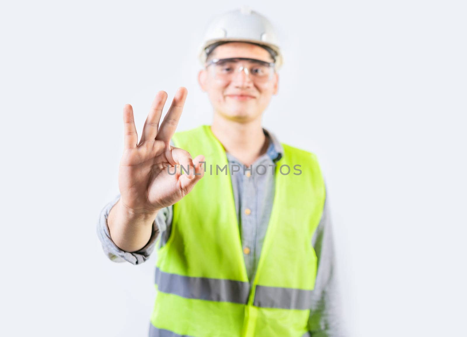 Young engineer counting number three isolated. Male engineer showing number three with fingers isolated