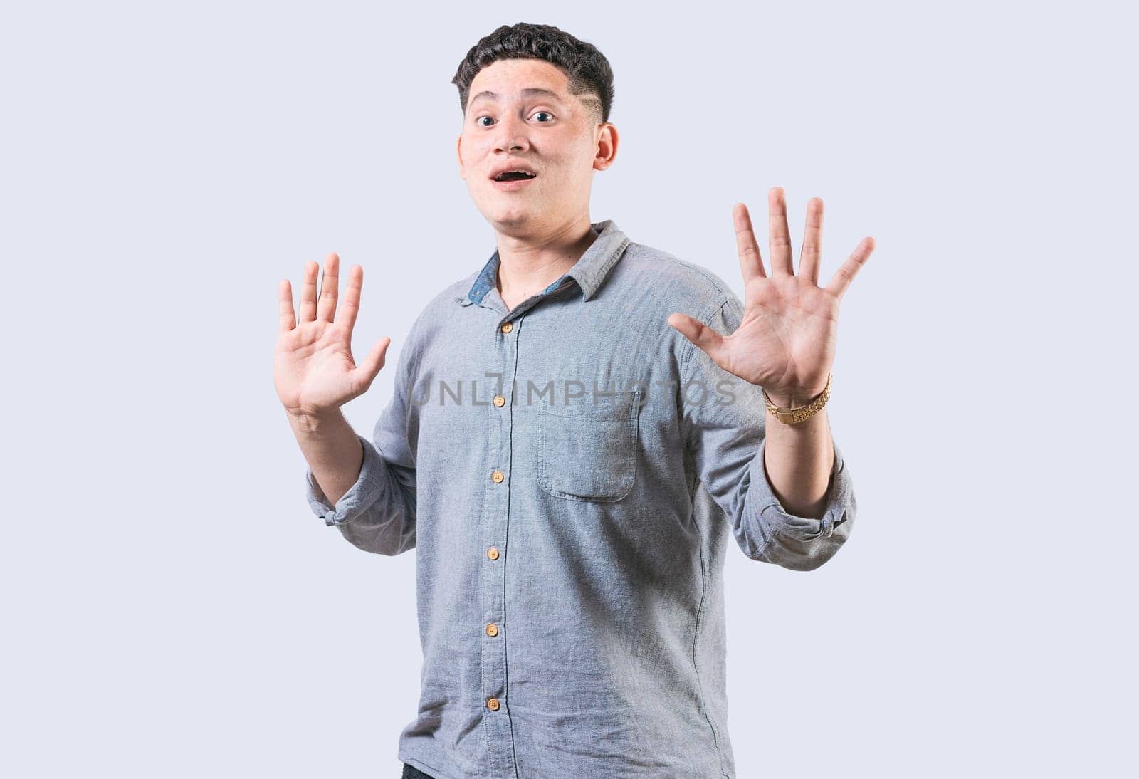 Scared man with raised hands isolated. Young man with scared face with raised hands. Scared and horrified guy with raised palms