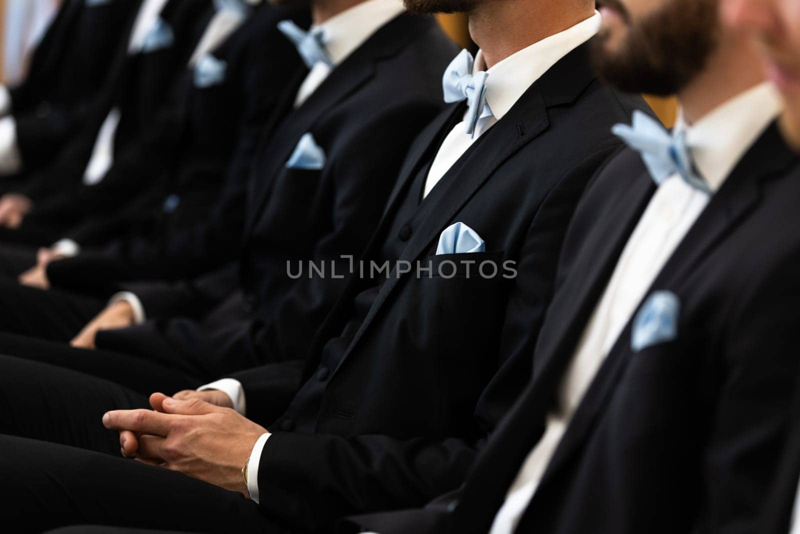 Guests sit on benches during a wedding in the Catholic Church.