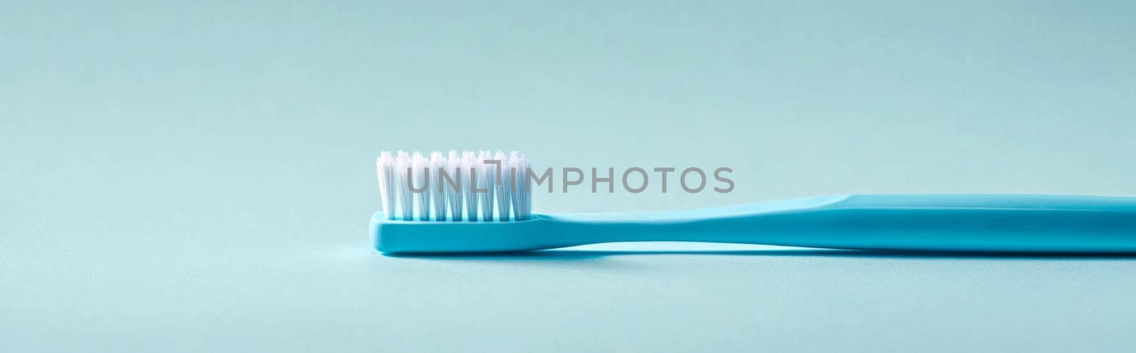 Toothbrush with blue handle on light blue background, concept of dental hygiene, AI Generated