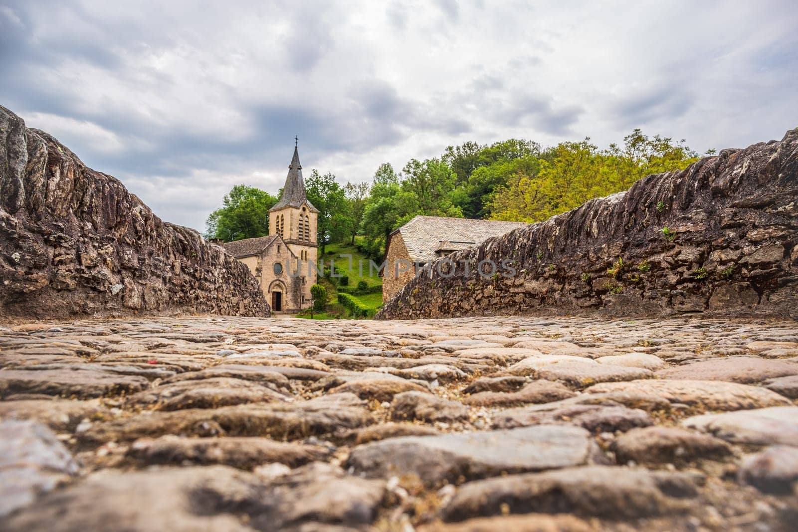 View from the cobblestones of the medieval bridge over the Aveyron in the old village of Belcastel, one of the most beautiful villages in France photographed in the Occitanie region