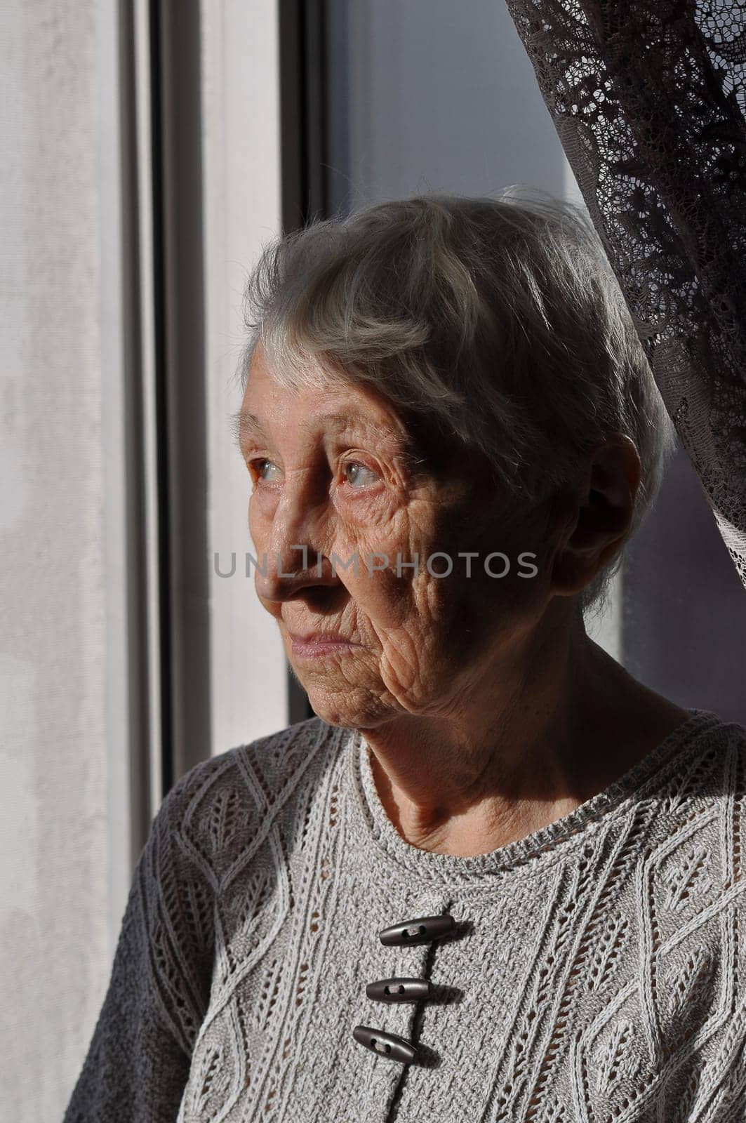 Head shot close up portrait of thoughtful senior woman worrying about personal health problems. Upset older female thinking of family troubles, feeling lonely, sitting at home.