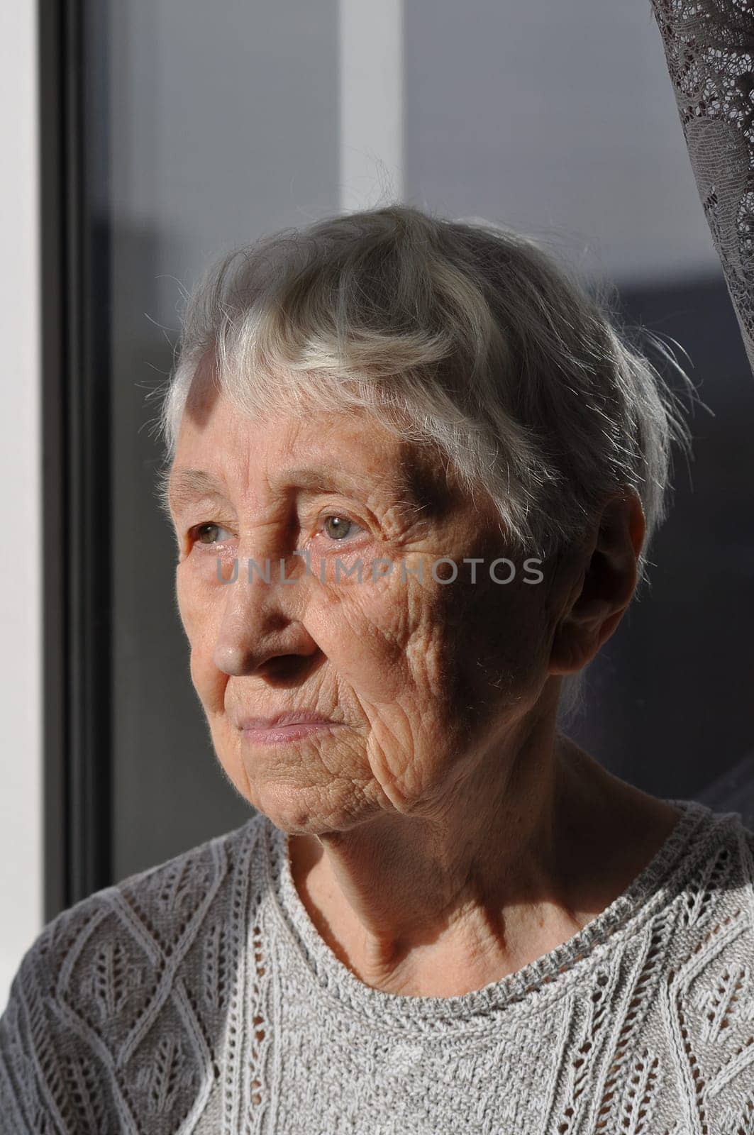 Head shot close up portrait of thoughtful senior woman worrying about personal health problems. Upset older female thinking of family troubles, feeling lonely, sitting at home.